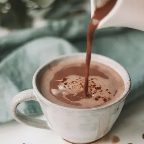 Chocolate mocha drink being poured into a cup